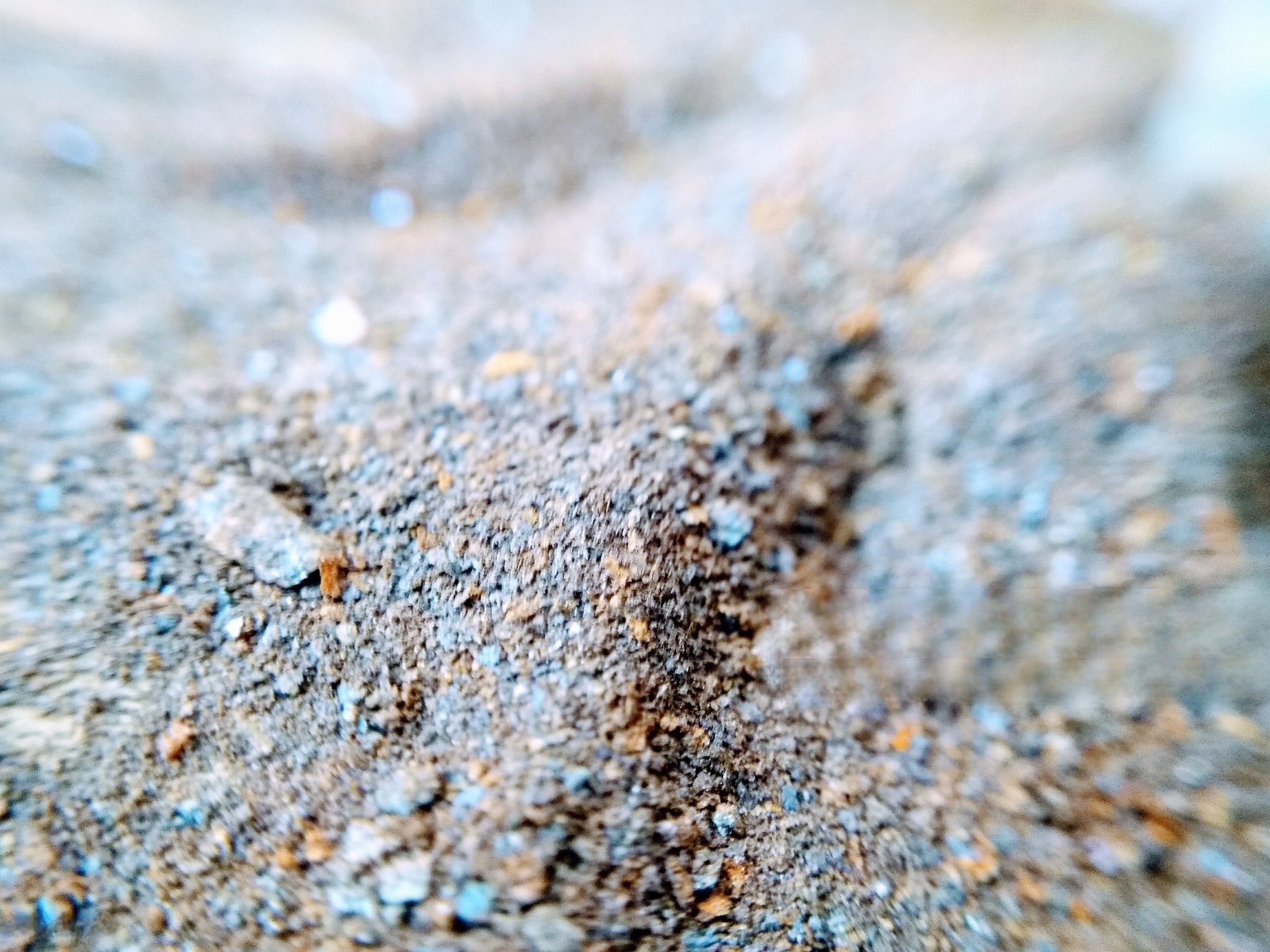 colored speckles being mixed with cement